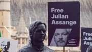 Statue von Julian Assange bei einem Protest in England, dazu Schilder, die für seine Freilassung appellieren..…             (Bild: RSF)